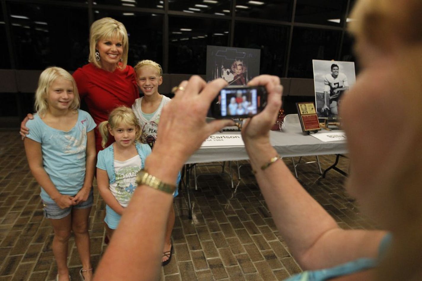 At Anoka High School on September 8, the first member of its new Hall of Fame were inducted. Fox television anchor and former Miss America, Gretchen Carlson, class of 1984, had a picture taken with fans Renee Doud,8, sister Rebecca,6, sister Rachel,10. "We watch her in the morning," said mother Brenda who took the picture.