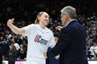 UConn guard Paige Bueckers embraces coach Geno Auriemma during senior night ceremonies after UConn defeated Georgetown. Bueckers then announced she wi