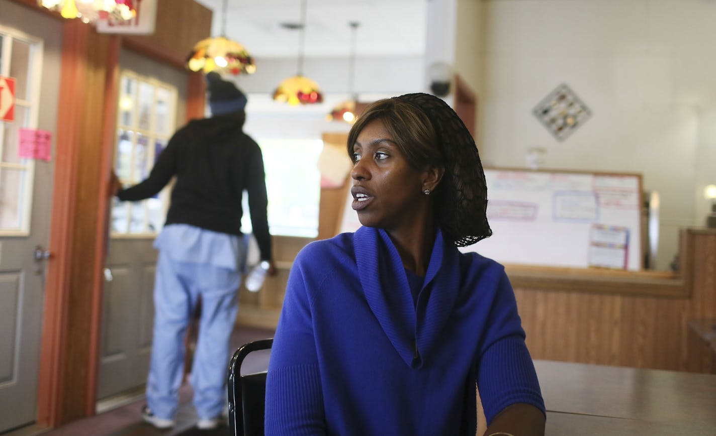 Since news of the early cases of Ebola in Liberia began to spread in the U.S. in August, business at Mama Ti's African Kitchen has plummeted by more than fifty percent, says Kellista Whisnant, who runs the restaurant. Whisnant, who is Liberian, and serves Liberian dishes says she wonders "if we can stay afloat. How can we survive this until this (ebola) rides out?" Whisnant said goodbye to a regular customer who was not Liberian at the restaurant Wednesday, Oct. 1, in Brooklyn Park, MN](DAVID JO