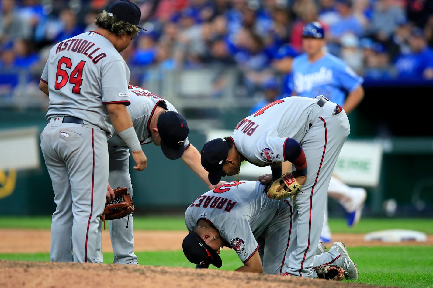 Twins third baseman Luis Arraez is checked on by teammates Willians Astudillo, Jorge Polanco and Tyler Duffey during the seventh inning