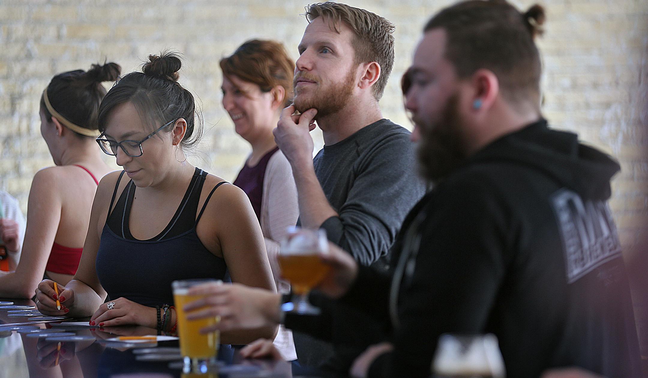 After a fitness class, Erik VanderEyk of Minneapolis contemplated the beer list.