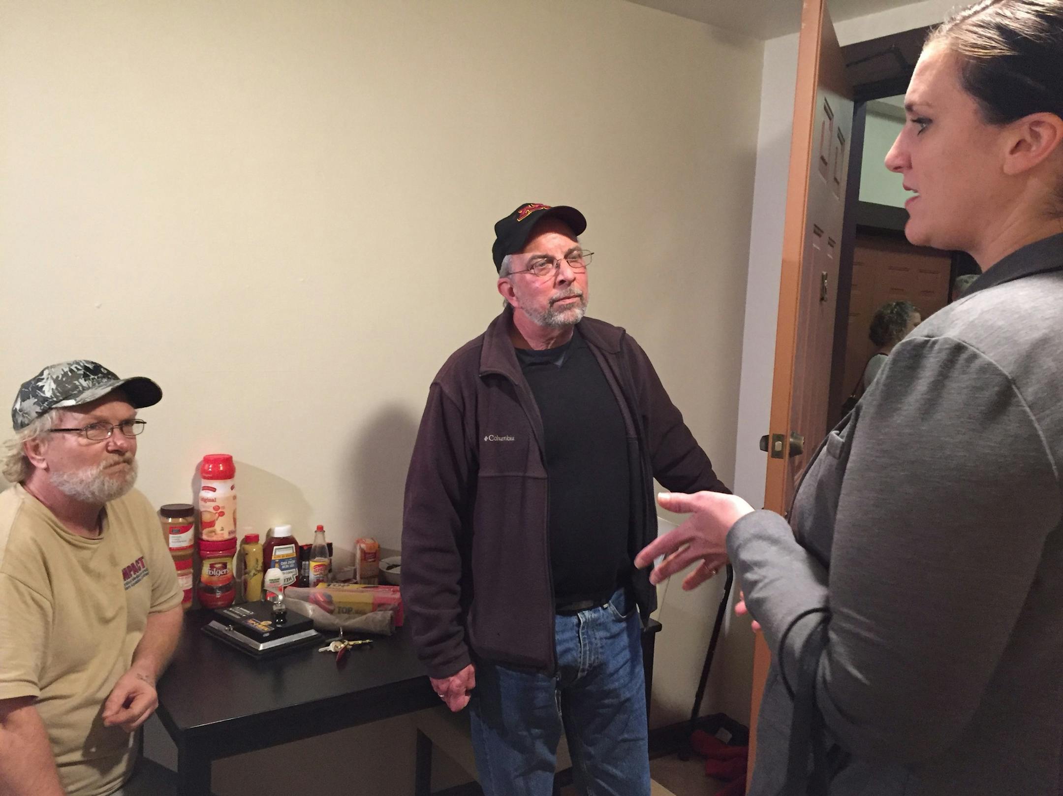 Emily Johnson Piper, commissioner of the Minnesota Department of Human Services, vists with tenant Ed Easterling, left, and staff member Bob Bono, center, recently at Alliance Housing Inc. after announcing the latest round of Live Well at Home grants.