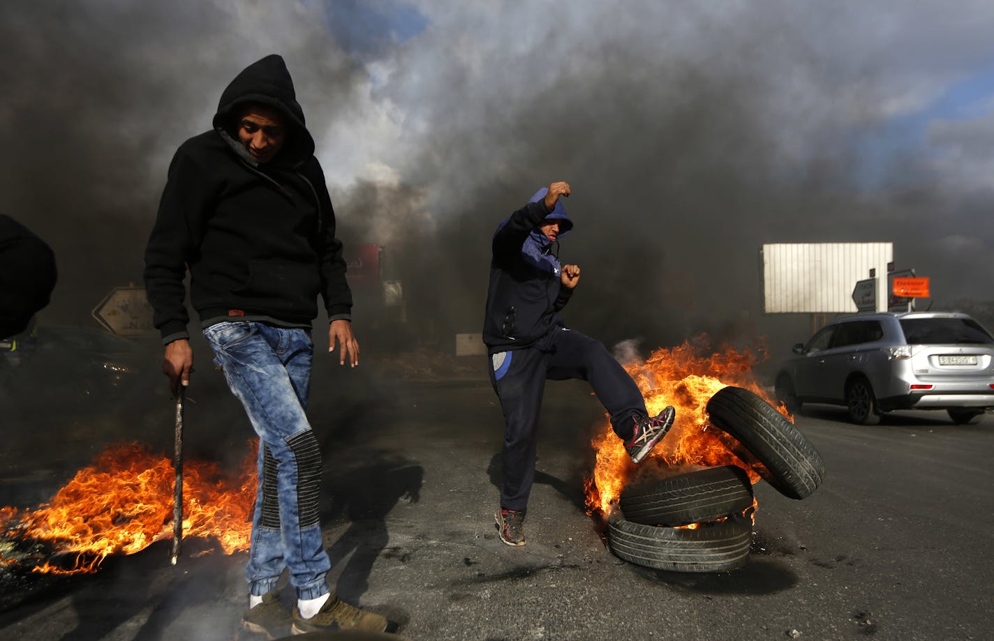 Palestinians burn tires during clashes with Israeli troops following a protest against U.S. President Donald Trump's decision to recognize Jerusalem as the capital of Israel, in the West Bank City of Nablus, Wednesday, Dec. 13, 2017. (AP Photo/Majdi Mohammed)