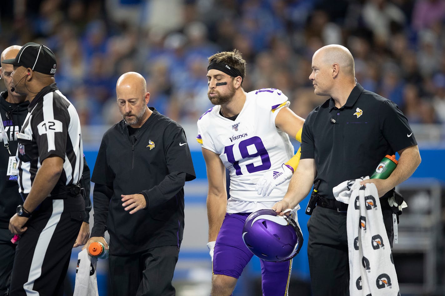 Vikings receiver Adam Thielen held his right hamstring as he walked of the field in the first quarter at Ford Field.