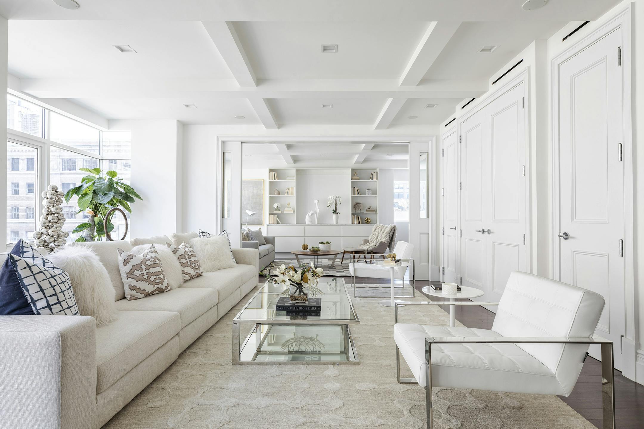 Various shades of white including a winter white sofa and area rug help create a crisp and clean look.