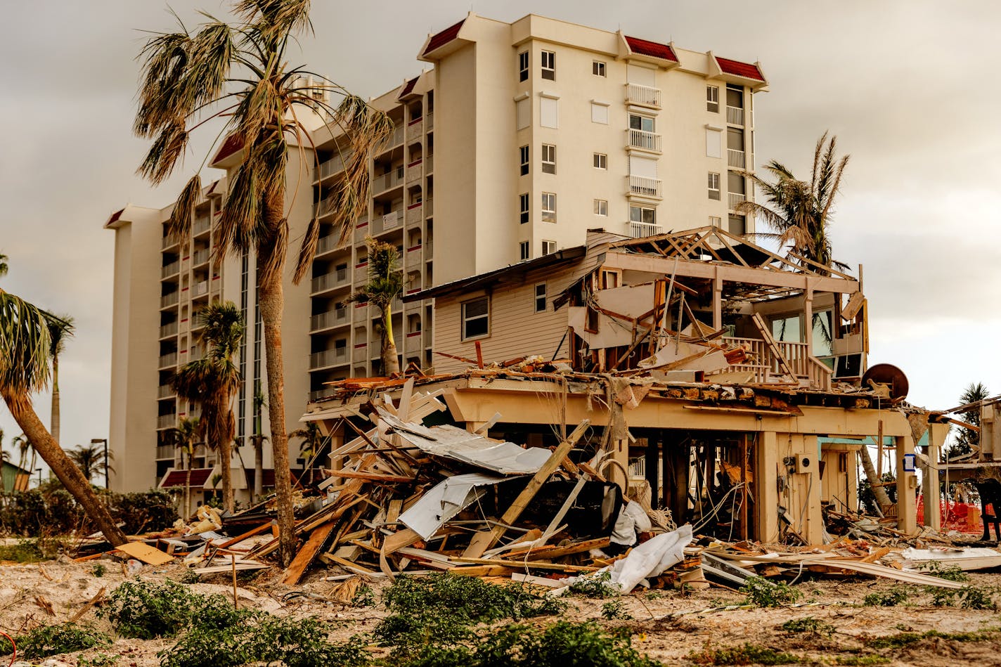 Homes and condominiums damaged by Hurricane Ian in Fort Myers Beach, Fla., Feb. 9, 2023. Communities like Fort Myers Beach, Sanibel and Captiva, devastated by the storm, are struggling to rebuild the hotel rooms, restaurants and rental units that keep their economy alive. (Scott McIntyre/The New York Times)