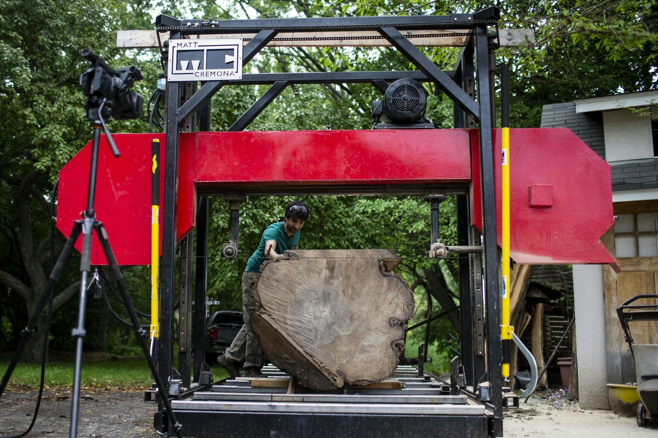 Matt Cremona saws a piece of Silver Maple on his backyard sawmill.