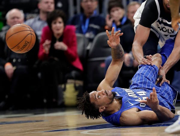Orlando Magic's Khem Birch, lower left, makes a pass to a teammate after grabbing a loose ball off the court during the second half of an NBA basketba