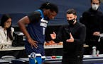 Timberwolves coach Ryan Saunders confers with center Naz Reid, who headed to the bench after getting into foul trouble during the first half against D