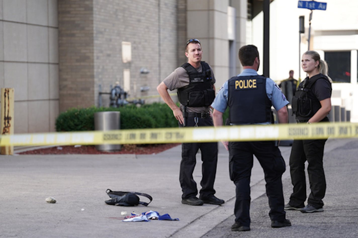 Minneapolis police officers investigated the scene where witnesses said a man working on a window cleaning crew was shot in Minneapolis's North Loop neighborhood on Friday, July 15, 2022.