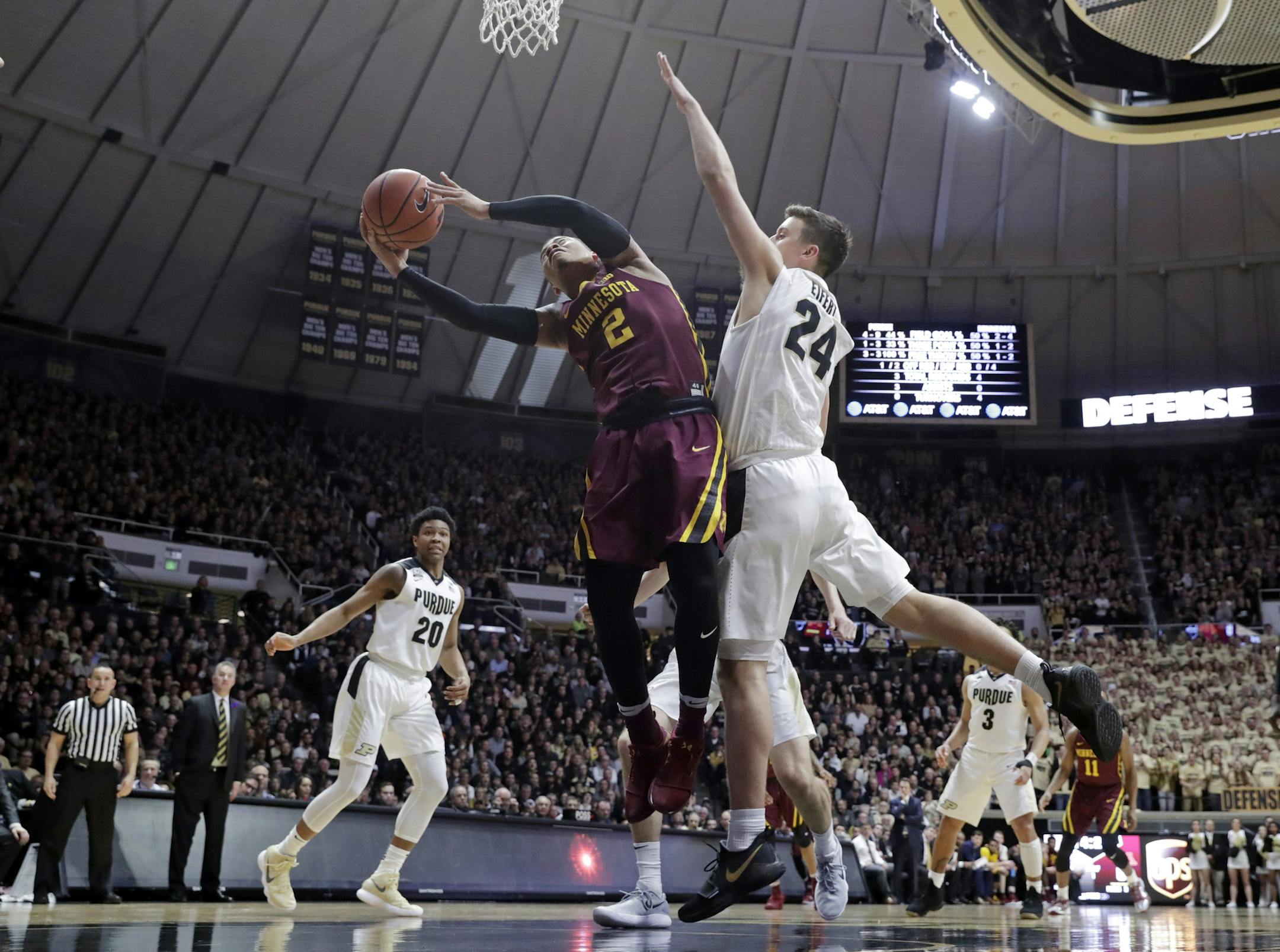 Minnesota guard Nate Mason (2) shoots under Purdue forward Grady Eifert (24) in the first half of an NCAA college basketball game in West Lafayette, Ind., Sunday, Feb. 25, 2018. (AP Photo/Michael Conroy)