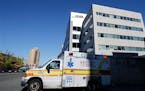 FILE- In this Oct. 27, 2014, file photo, an ambulance drives near University Hospital of Newark in Newark, N.J. Nurse Kaci Hickox, who was quarantined
