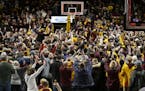 Minnesota fans storm the court after an upset victory over Ohio State in an NCAA college basketball game Sunday, Dec. 15, 2019, in Minneapolis. (AP Ph