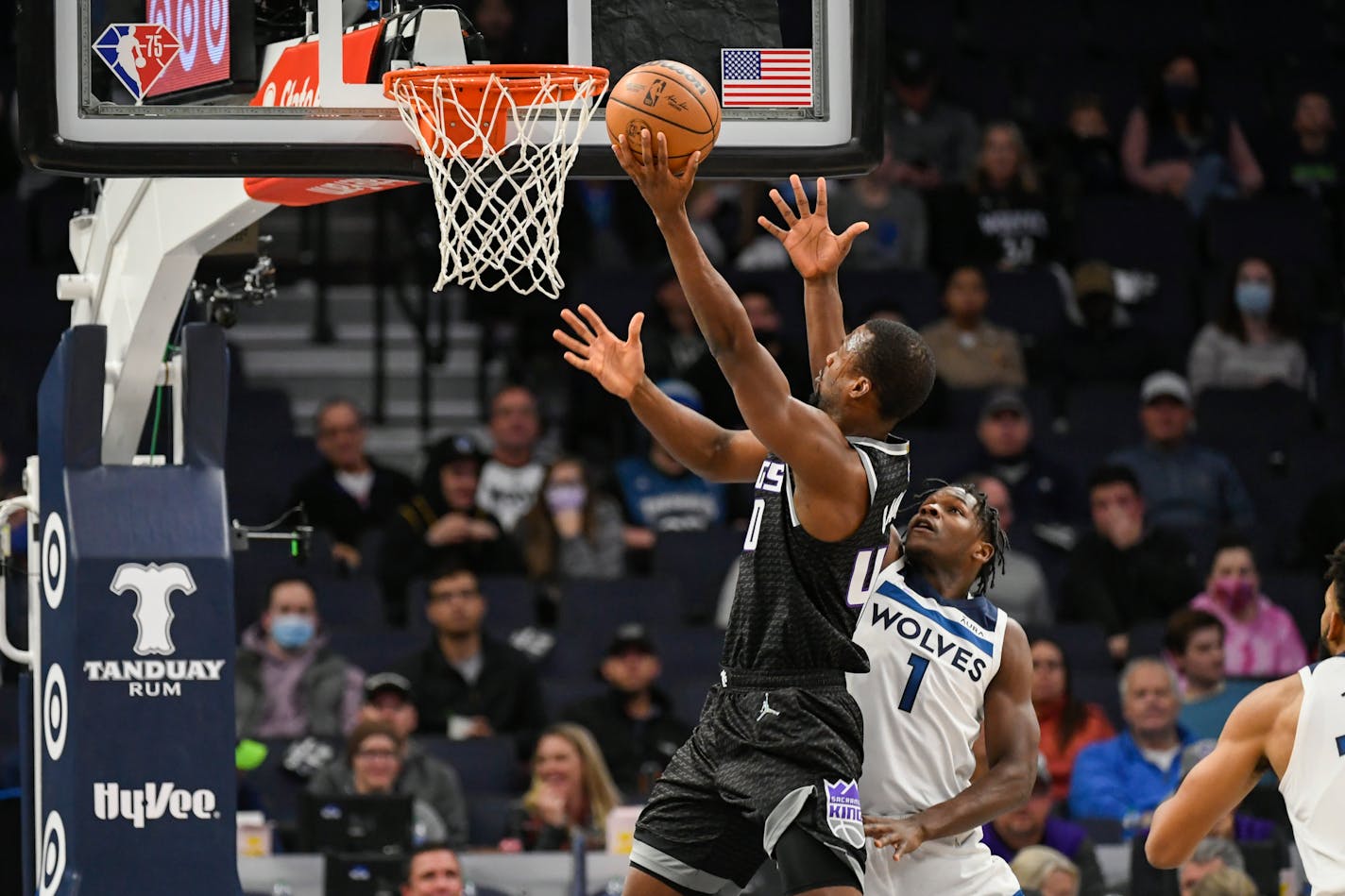 Sacramento Kings forward Harrison Barnes, left, drives past Minnesota Timberwolves guard Anthony Edwards to score during the first half of an NBA basketball game Wednesday, Nov. 17, 2021, in Minneapolis. (AP Photo/Craig Lassig)