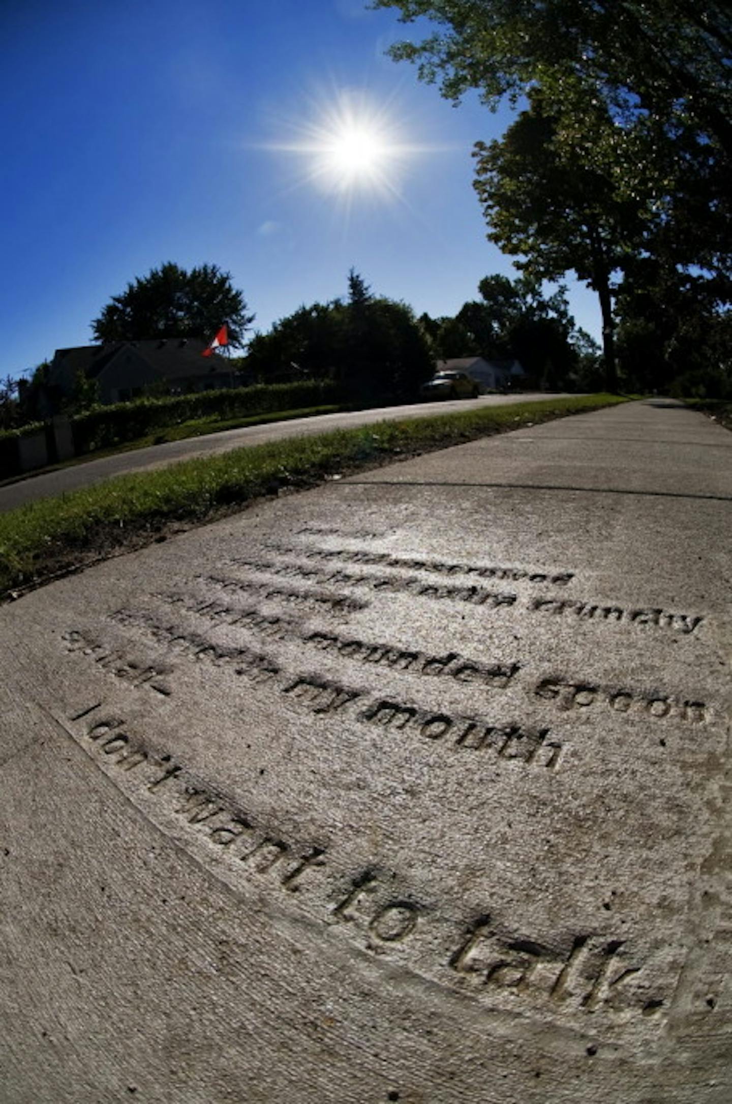 Poetry, embedded in a sidewalk in St. Paul's Como neighborhood. Staff photo by David Brewster