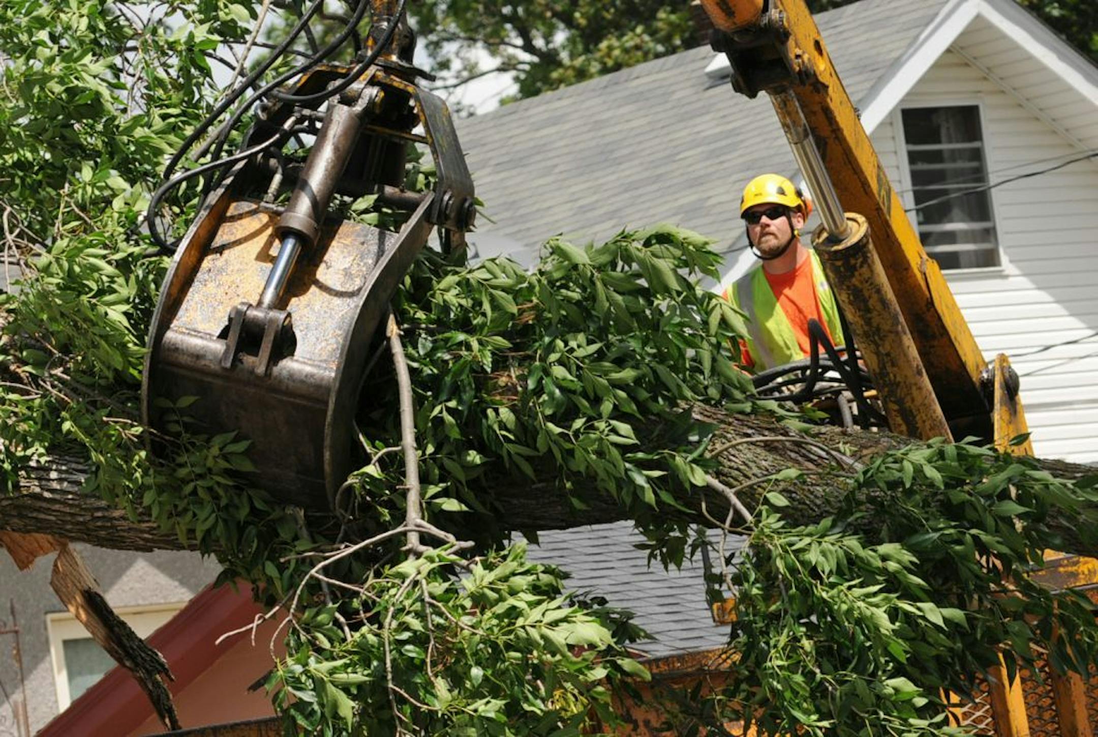 Thousands of people lost electrical power as trees and power lines were toppled by severe thunderstorms that rattled through the metro Sunday night. St Paul's Highland Park neighborhood was hit hard by straight line winds . St Paul Parks and Recreation workers cleaned up limb damage. Ted Kocienda a forester with St Paul Parks and Recreation used a claw to hoist tree damage, as crews cleaned up tree damage on Macalester St. in St Paul, Monday afternoon, june11, 2012.