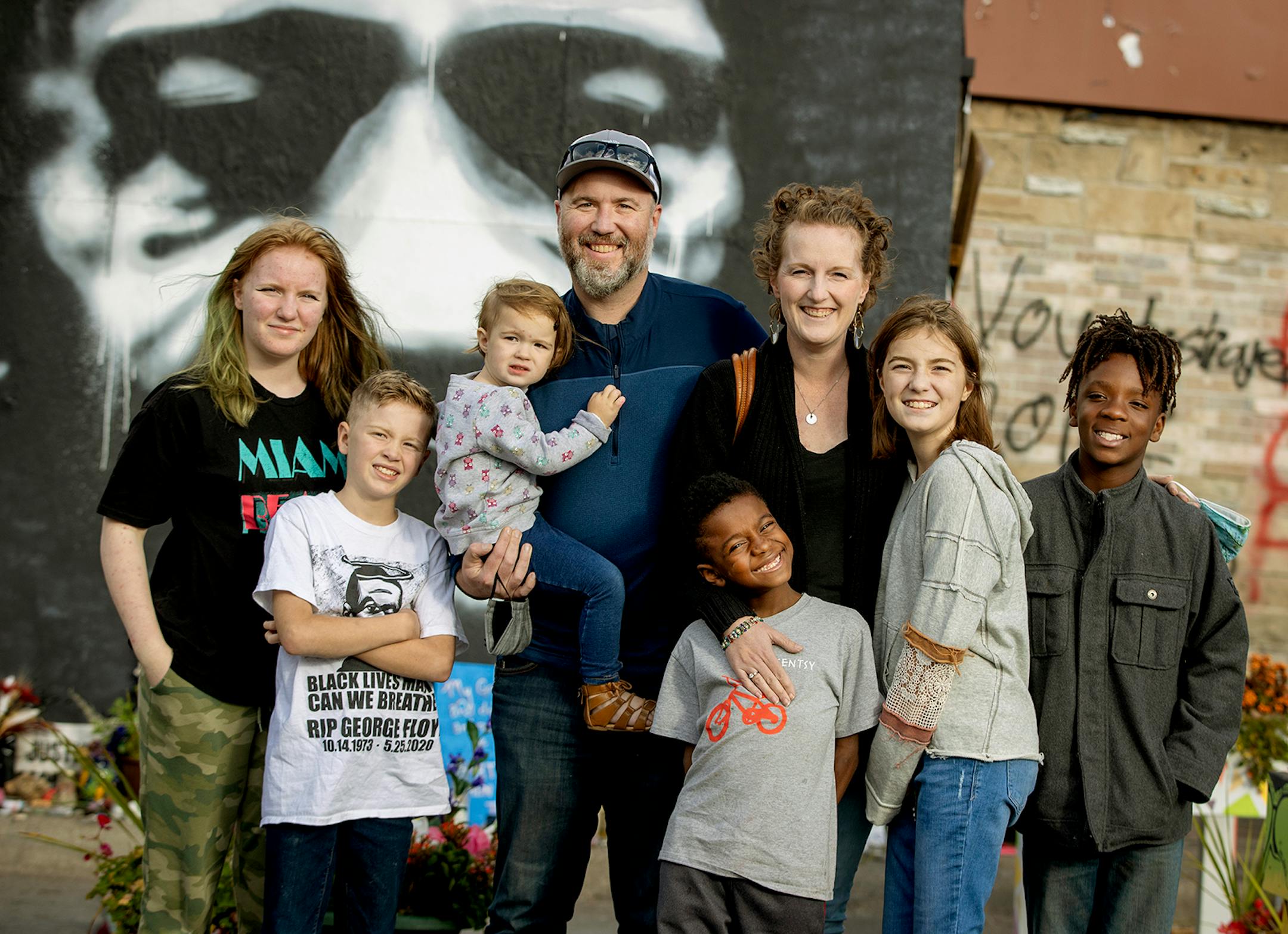 The Lundquist family including from left, Addi, 14, Ridge, 9, Verabeth, 2, Jacob Lundquist, Maki, 8, Kate Lundquist, Charlotte, 11, and Nelson, 11, moved from Roseau, MN to Brooklyn Park after a decision the family made after visiting the George Floyd memorial in June. Here, the family visited the memorial, Wednesday, September 30, 2020 in Minneapolis, MN. The Lundquists wanted to move from the overwhelmingly white rural town so their children of color could see others like them.