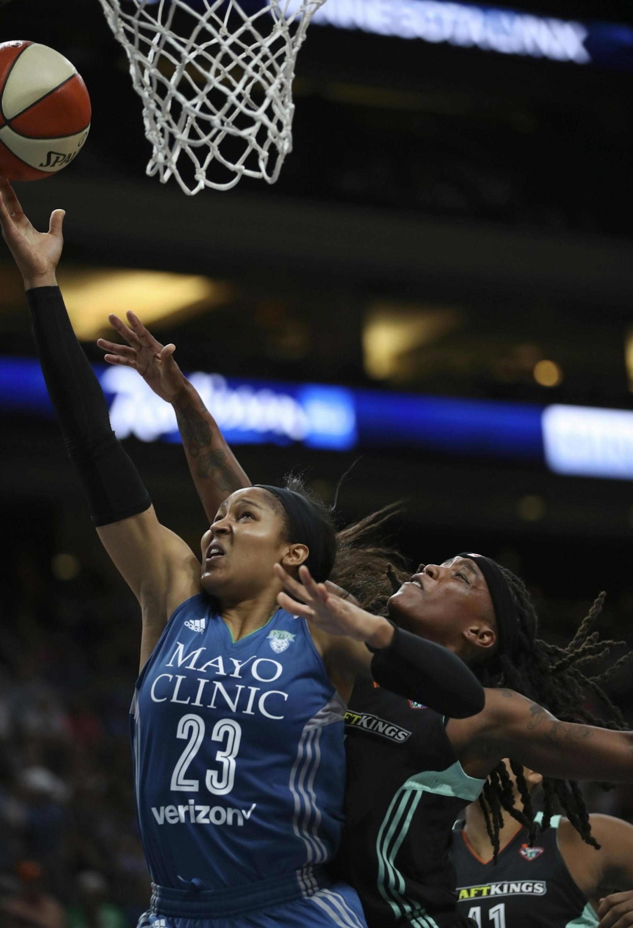 Minnesota Lynx forward Maya Moore (23) made a second quarter layup while defended by New York Liberty guard Shavonte Zellous (1).