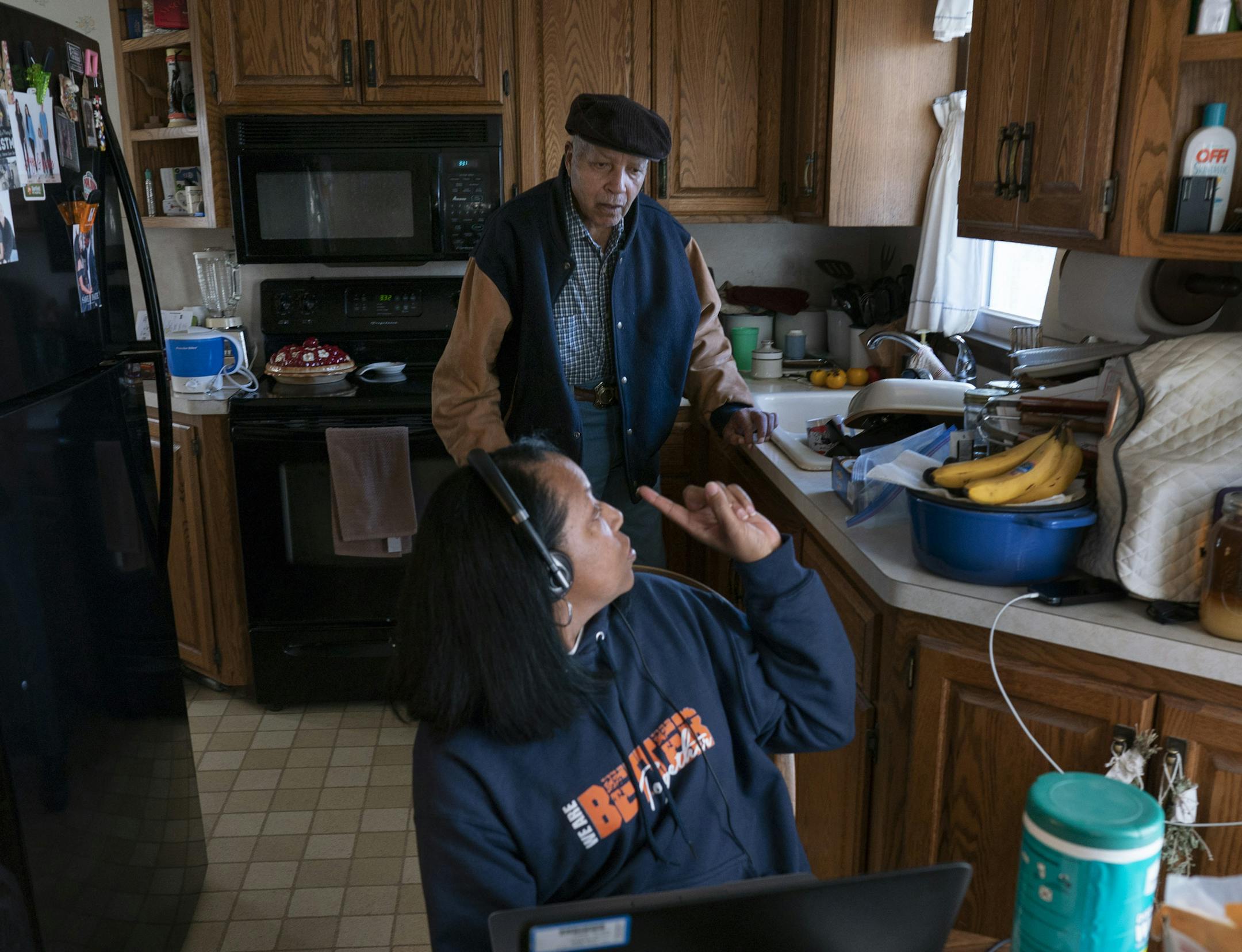 Karen Martin held a work conference call and responded to her dad, Chris, who lives in his own home in south Minneapolis and has dementia.