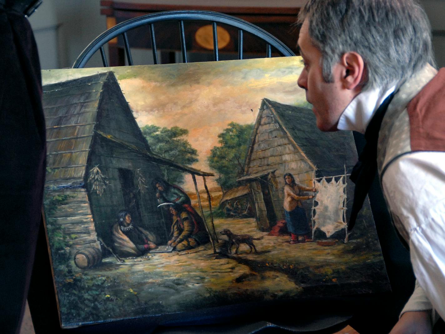 David Geister, who is impersonating artist Seth Eastman for the show, studied the oil painting under investigation. Eastman "felt Native American people were vanishing and wanted to record them in their natural environment," Geister said.