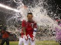 Twins' Oswaldo Arcia received a Gatorade shower just before he was going to do a post-game interview after his walk off home run gave the Twins a vict