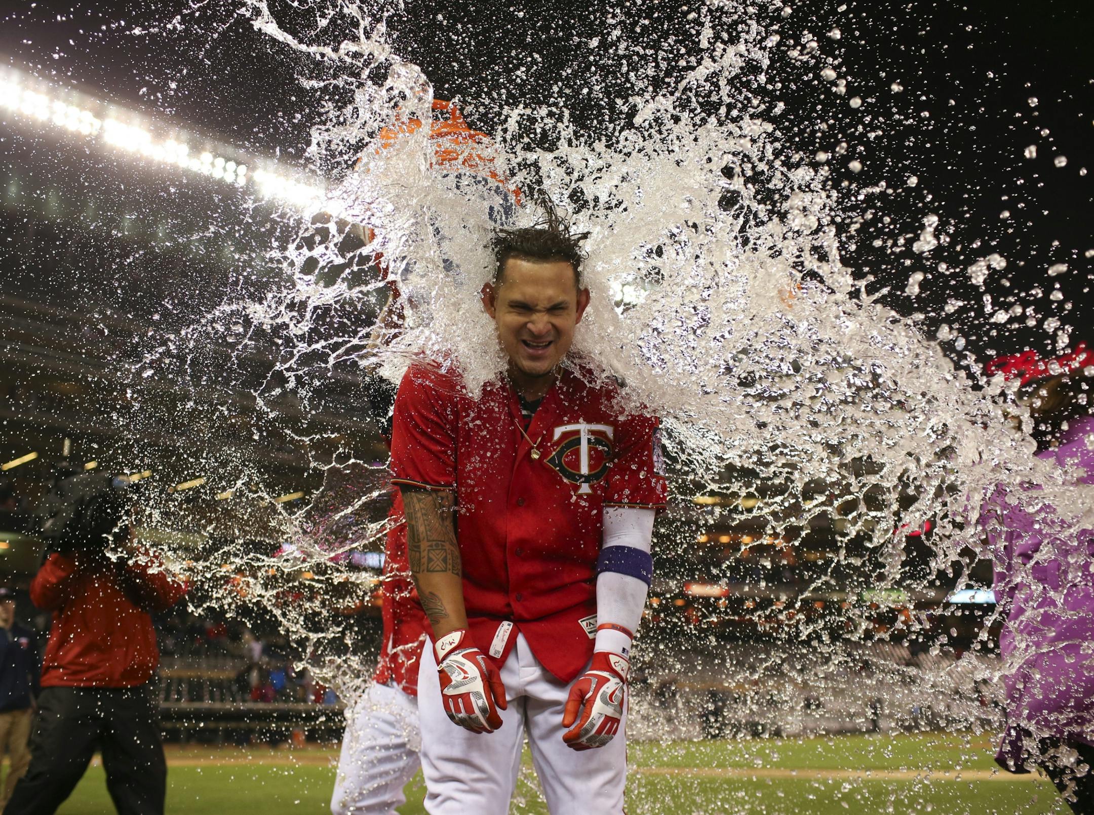 Twins' Oswaldo Arcia received a Gatorade shower just before he was going to do a post-game interview after his walk off home run gave the Twins a victory in April.