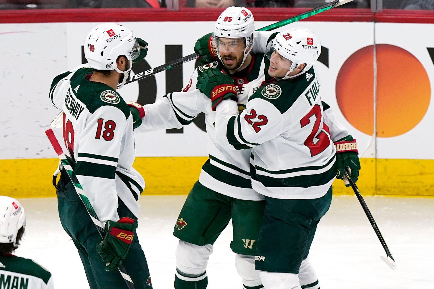 Minnesota Wild center Frederick Gaudreau celebrates with Jordan Greenway, left, and Kevin Fiala after scoring a goal during the second period