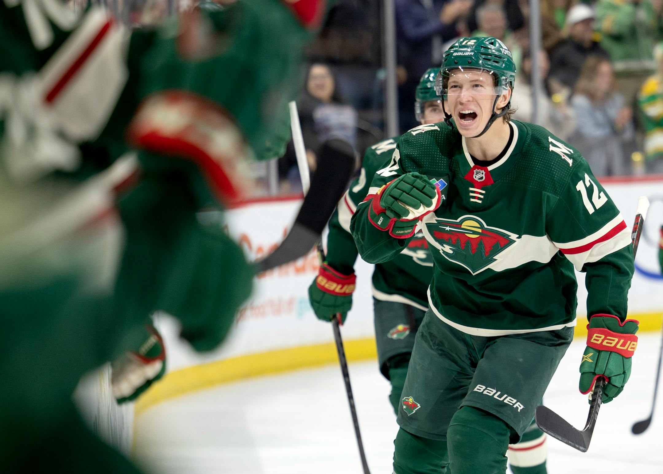 Matt Boldy (12) of the Minnesota Wild celebrates with teammates after scoring a goal in the second period.