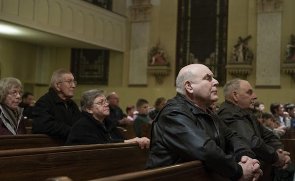Ralph Miller, left and his brother Bill Miller attended mass at Sacred Heart Church in Polonia, Wis., on the anniversary of the death of their sibling