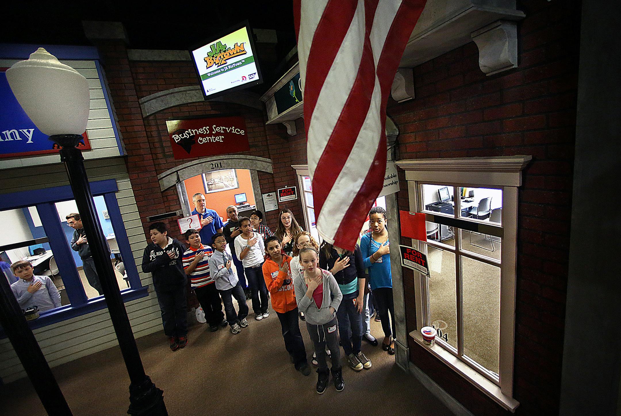Participants at JA BizTown recited the Pledge of Allegiance before beginning their work day. ] (JIM GEHRZ/STAR TRIBUNE) / April 2, 2013 / 11:00 AM Maplewood, MN ‚Äì BACKGROUND INFORMATION- Fourth and 5th grade Students from Greenleaf and Westview Elementary schools in the Rosemount-Apple Valley-Eagan School District spent a day recently learning how to run a business in a program put on by Junior Achievement. Students learned how to do payroll and taxes and pay utilities in a si