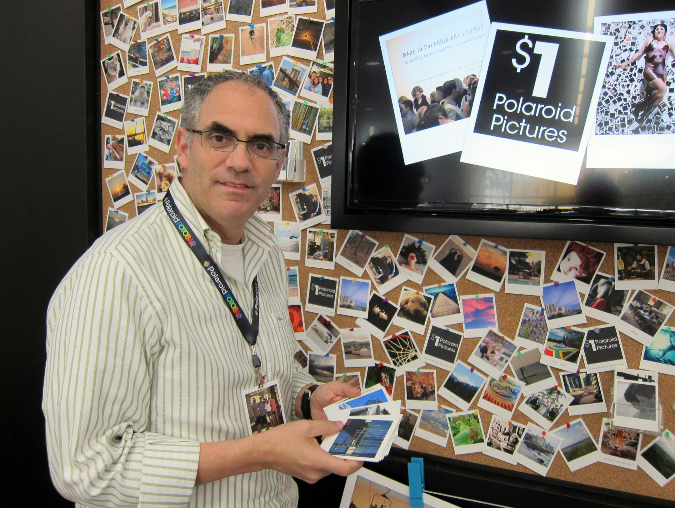 Polaroid Fotobar founder and CEO Warren Struhl, stands in his Delray Beach, Fla., store on its opening day Friday, March 1, 2013. The 2,000 square-foot store hopes to reinvigorate the digital world's interest in print photography. Polaroid's new store aims to coax customers to move images off their cell phones and unto paper, canvas, metal, bamboo or other materials. (AP Photo/Matt Sedensky)