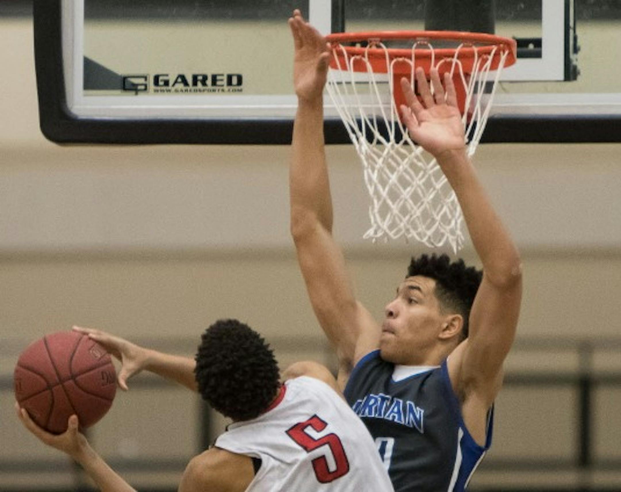 North St. Paul center Adreon Wadlington (5) went up but was blocked by Tartan forward Jarvis Thomas in the Class 4A, Section 4 boys' basketball title game in March 2016 at East Ridge High School.