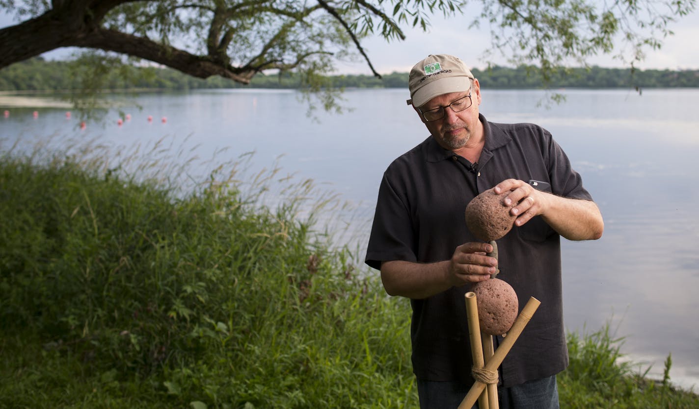 Peter Juhl worked on a sculpture last month at Lake Harriet in Minneapolis. "I want to create something that's on the very edge of falling down," he said. "It's ephemeral."