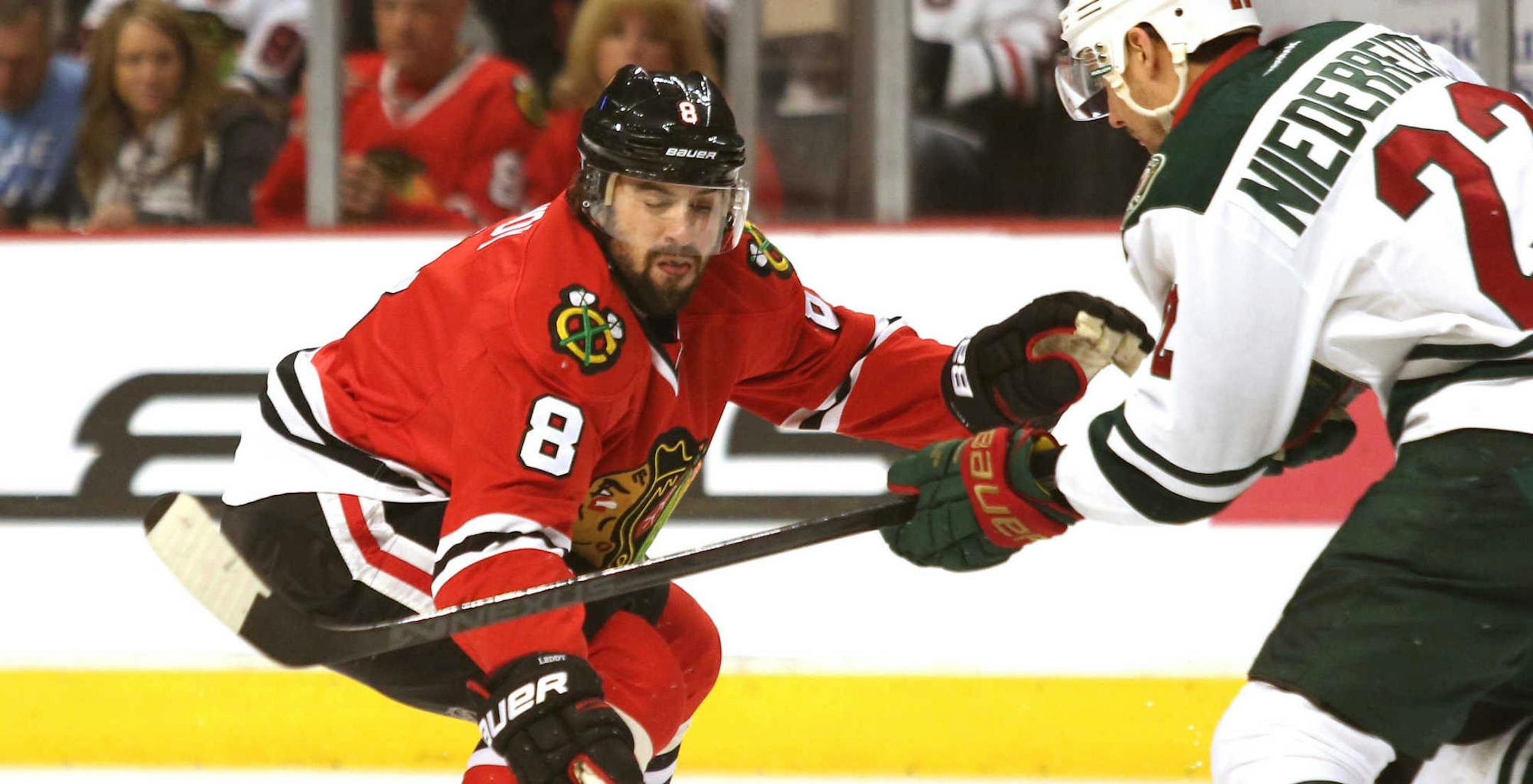 Chicago Blackhawk defenseman Nick Leddy pressures the Wild's Nino Niederreiter, right, during Game 1 of an NHL hockey second-round playoff series in Chicago, Friday, May 2, 2014. The Blackhawks won 5-2. (AP Photo/Daily Herald, Daniel White )