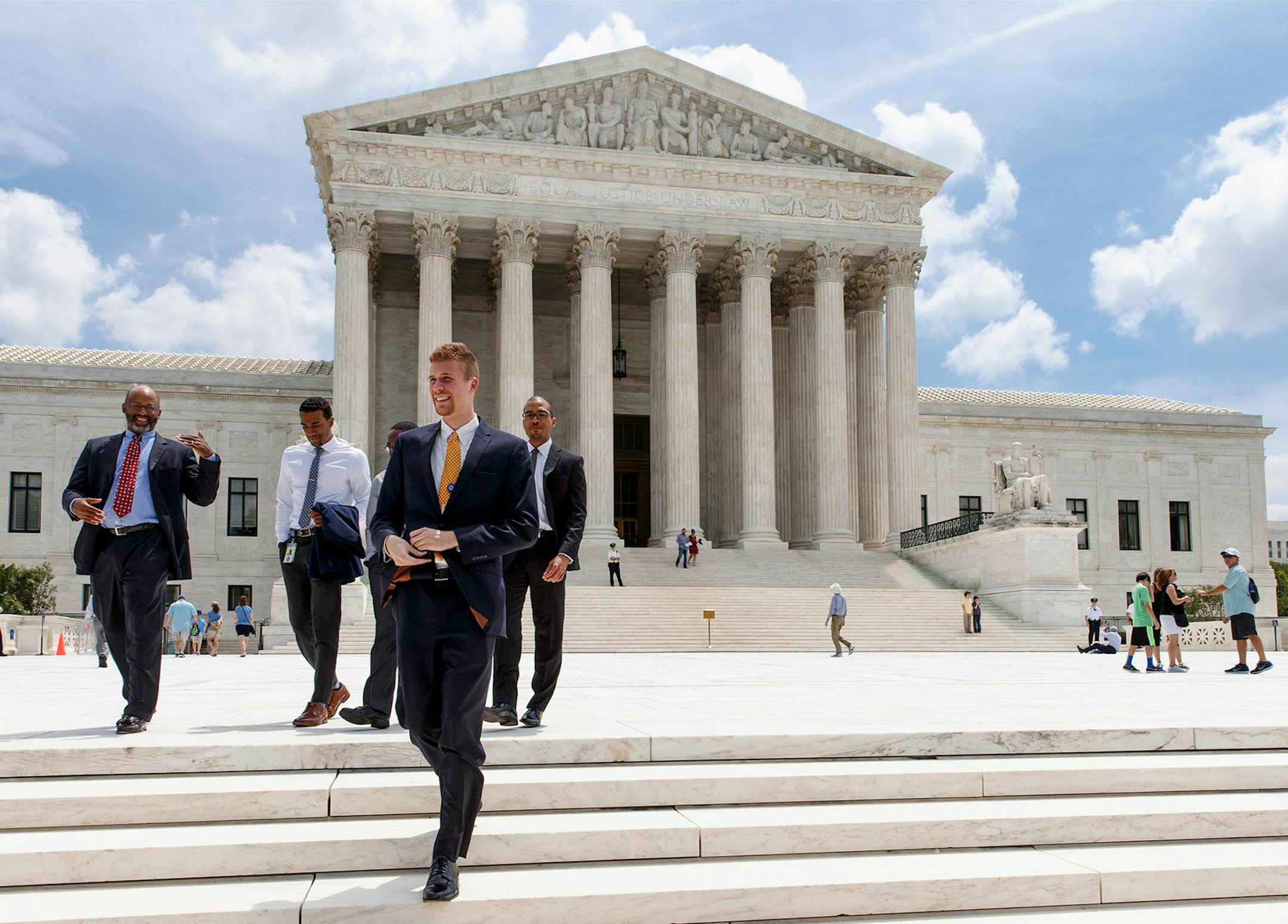 People leave the Supreme Court in Washington, Thursday, June 26, 2014, in the final days of its term. The court struck down a 35-foot protest-free zone outside abortion clinics in the state of Massachusetts. The justices were unanimous in ruling that extending a buffer zone 35 feet from clinic entrances violates the U.S. Constitution's First Amendment rights of protesters. (AP Photo/J. Scott Applewhite)