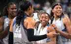 Minnesota Lynx players congratulate guard Renee Montgomery during the second half of the team's WNBA basketball game against the Los Angeles Sparks on