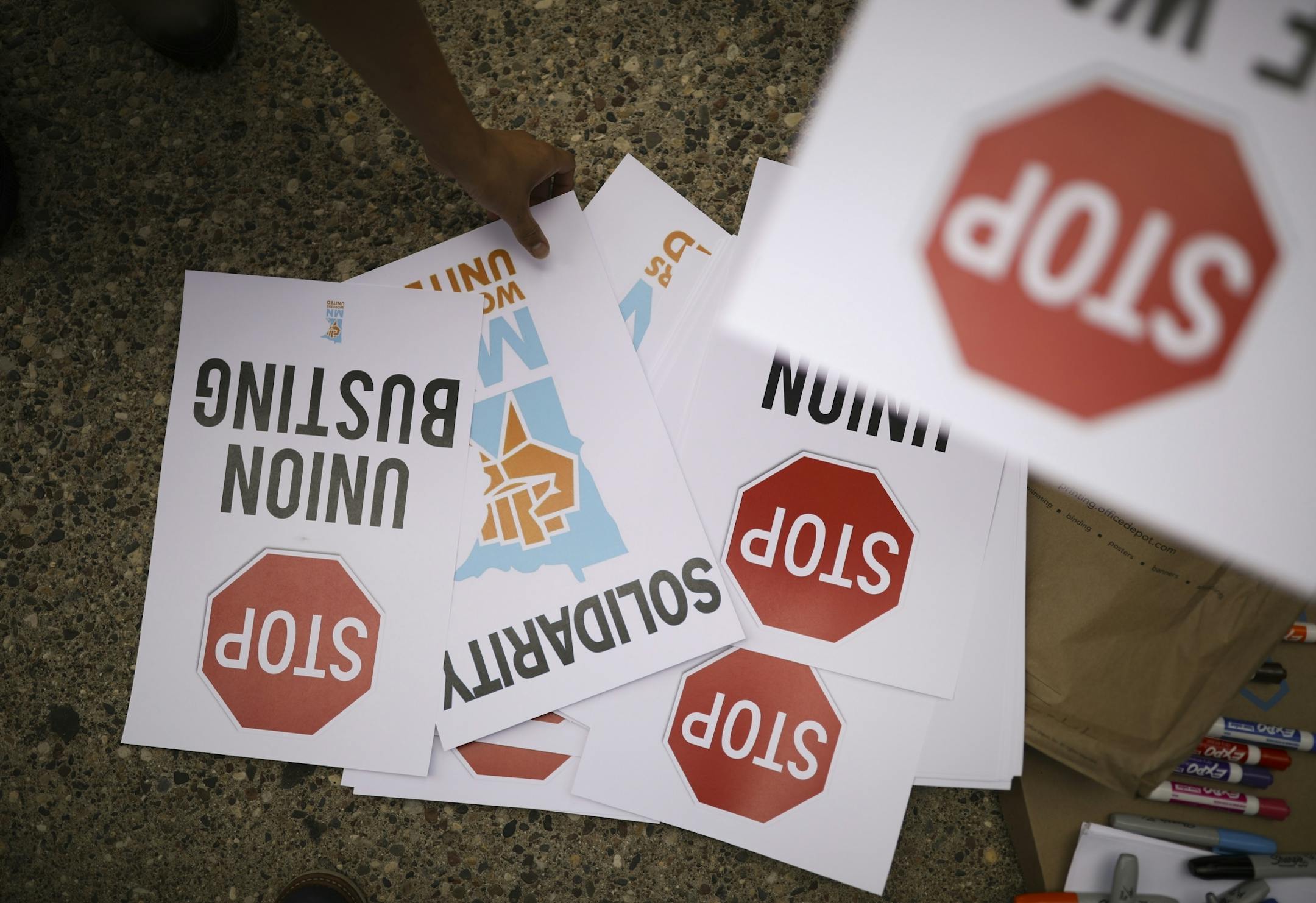 People picked up signs at the start of the demonstration.