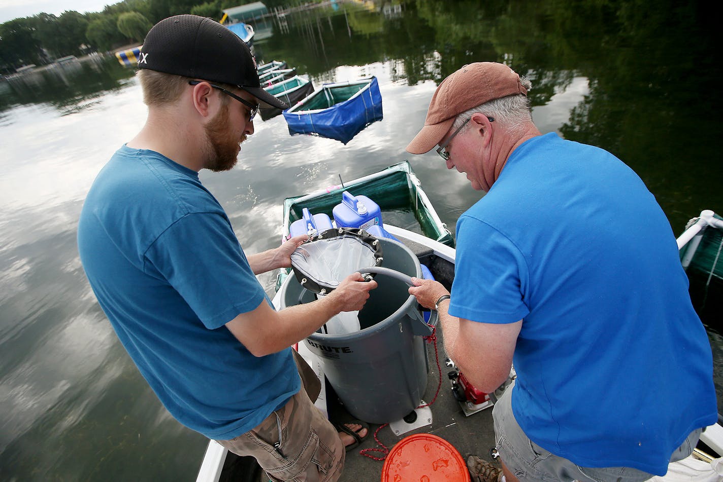 University of Minnesota AIS Research Center's Dr. Michael McCartney, right, and Max Kleinhans, left, tested a project targeting tiny zebra mussels with low doses of a copper-based pesticide in Robinson Bay on Lake Minnetonka, Wednesday, July 20, 2016 in Wayzata, MN. ] (ELIZABETH FLORES/STAR TRIBUNE) ELIZABETH FLORES &#x2022; eflores@startribune.com