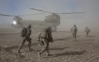 FILE -- American soldiers with the 101st Airborne Division during a morning helicopter raid in the village of Alam Khel, Afghanistan, Jan. 23, 2011. D