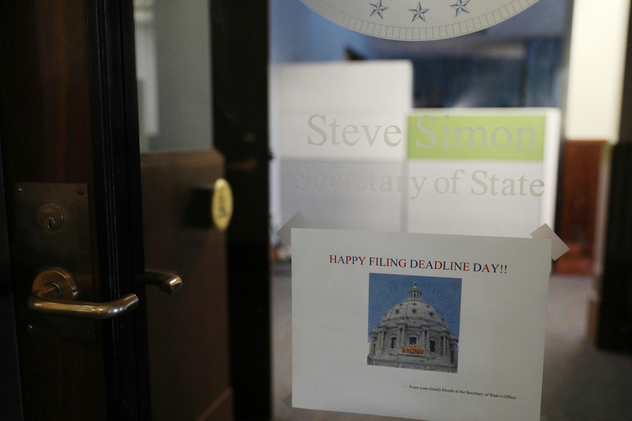 A sign wishing a happy filing day was taped to Secretary of State Steve Simon's door as candidates rushed to file to run for Keith Ellison's congressional seat.