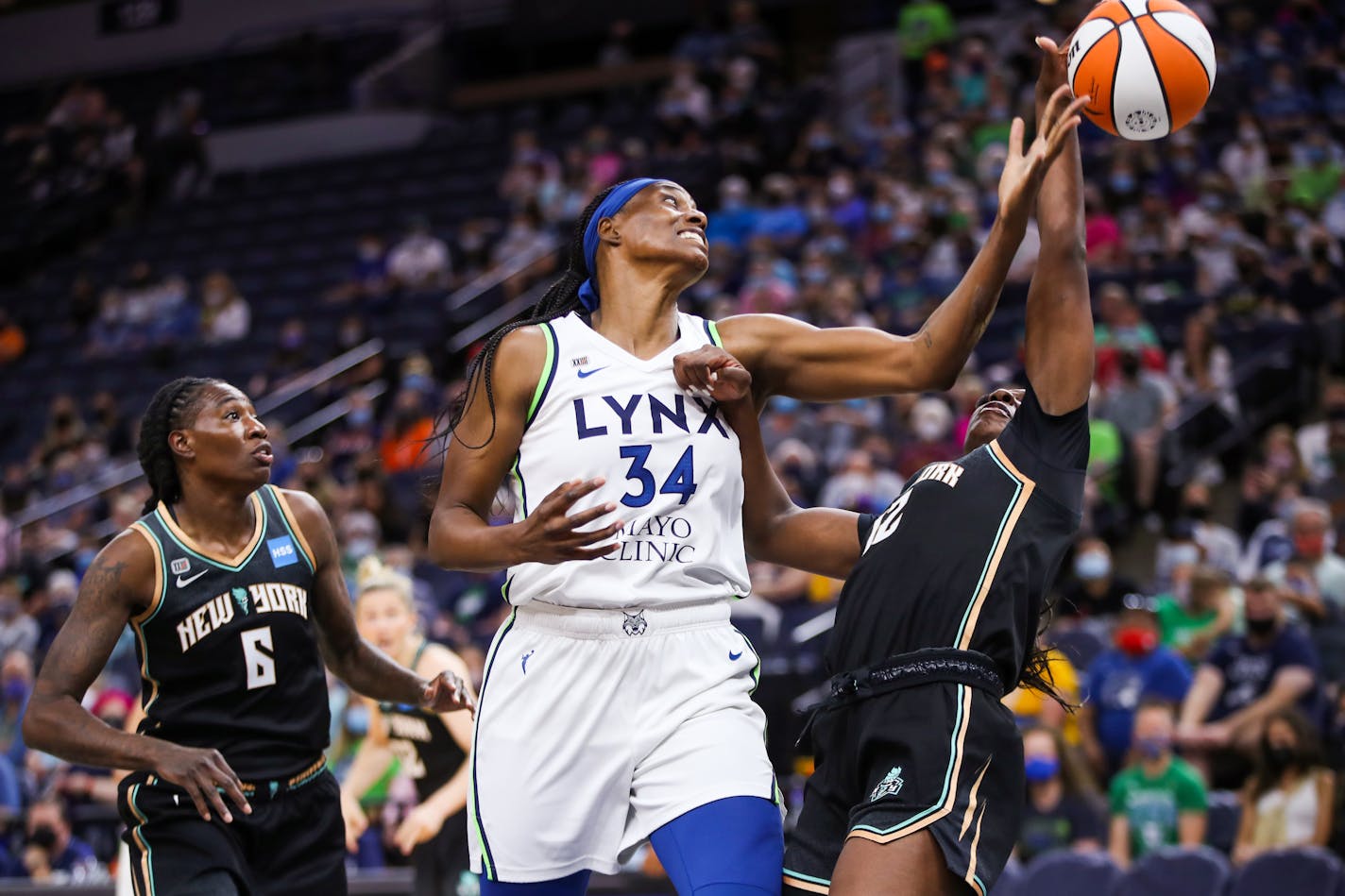 Lynx center Sylvia Fowles (34), center, fights for a rebound with Liberty forward Michaela Onyenwere (12), right as Liberty forward Natasha Howard (6), left, watches during the first half against the New York Liberty at Target Center on Sunday, Aug. 15, 2021, in Minneapolis. ] ANTRANIK TAVITIAN • anto.tavitian@startribune.com