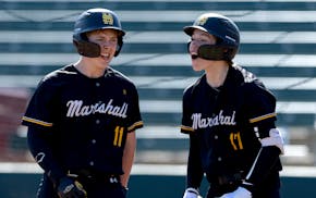John Cordero (11) and Easton Grumdahl (17), of Duluth Marshall, celebrate a run scored by Cordero in the second inning against Proctor High School at