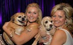 From left, Sydnie Collins and Gracie, a Puggle, and Tracie Collins and Nala, a Cocker Spaniel.