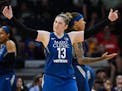 Minnesota Lynx guard Lindsay Whalen (13) tried to bring some energy into the crowd as guard Seimone Augustus (33) argued against a technical foul in t