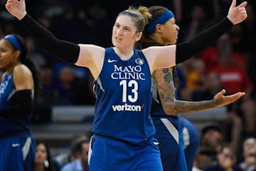 Minnesota Lynx guard Lindsay Whalen (13) tried to bring some energy into the crowd as guard Seimone Augustus (33) argued against a technical foul in t