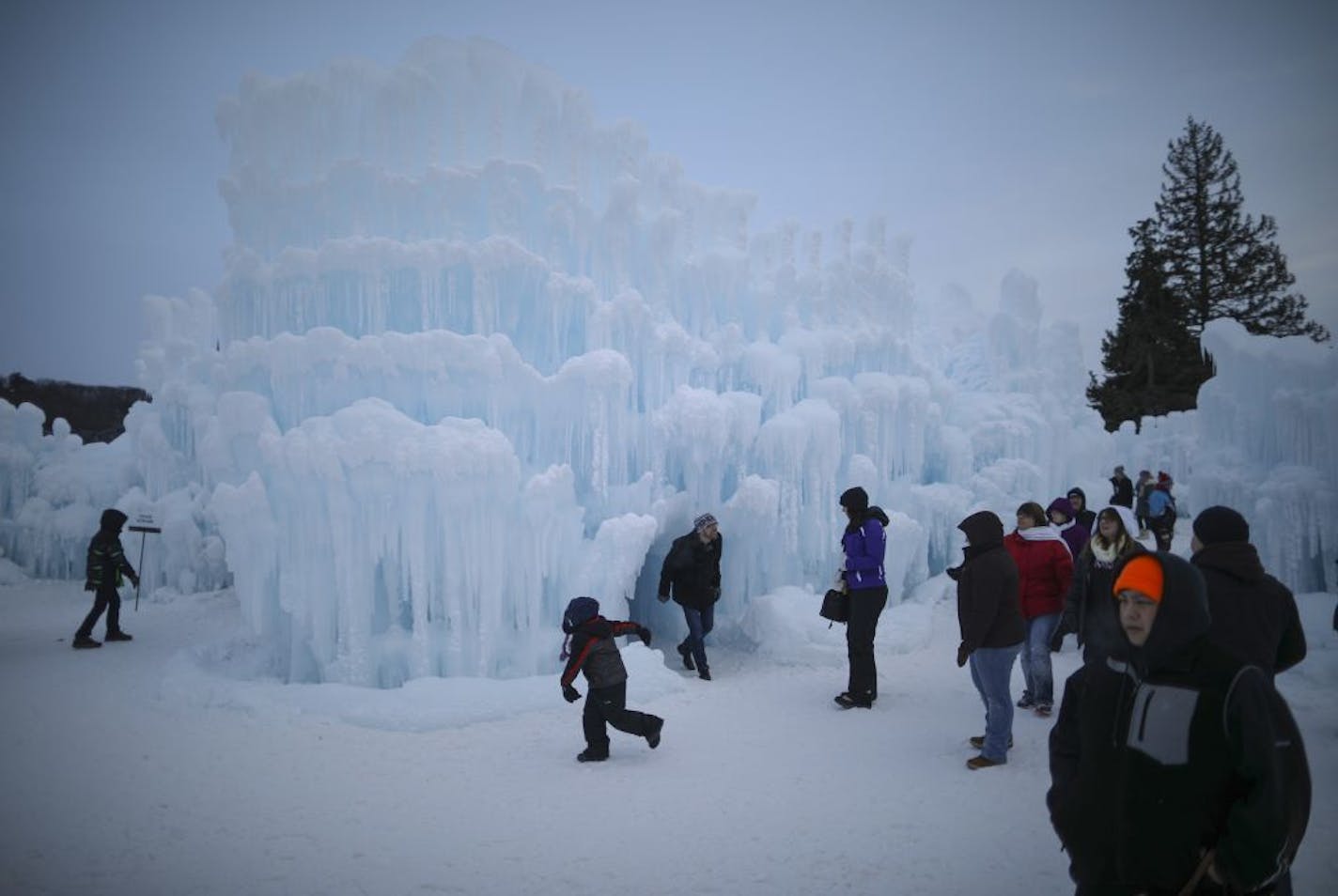 Visitors inside the Ice Castles at the Lift Bridge Sunday night.