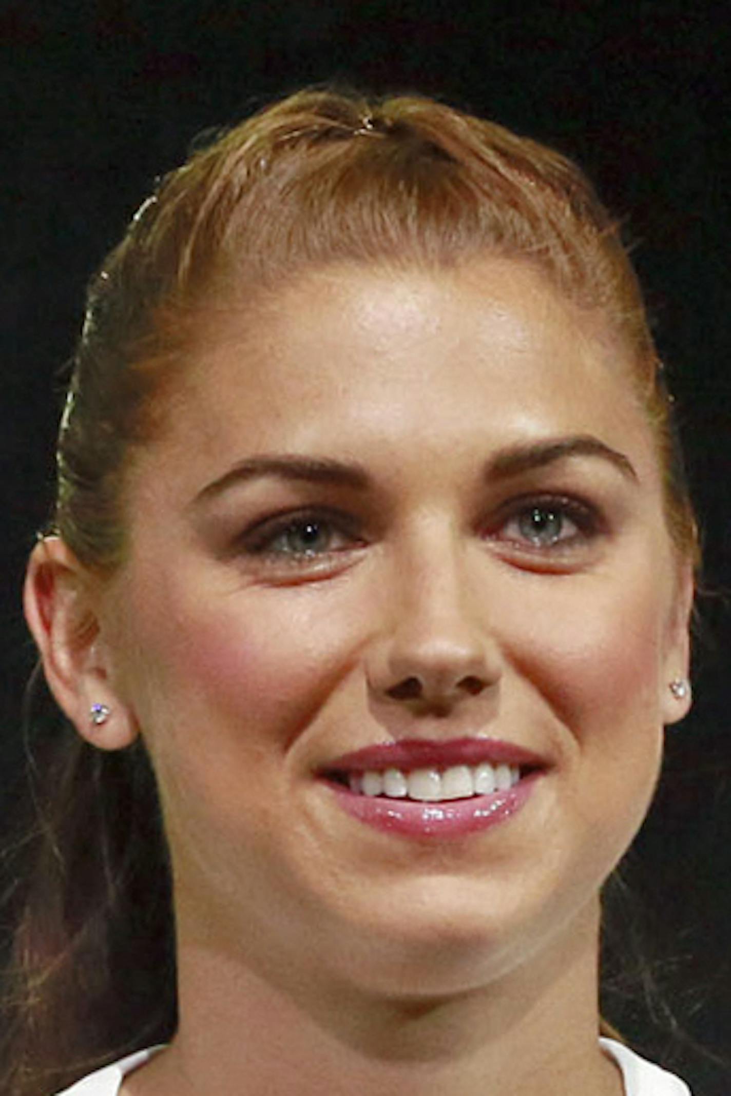 FILE - In this April 22, 2015, file photo, United States forward Alex Morgan poses in the new black and white home uniform for the U.S. women's World Cup soccer team during a news conference in Los Angeles. Morgan&#xed;s star rose quickly following her performance in Germany four years ago, when - as the youngest player on the U.S. World Cup team - she became a super sub with a goal and an assist in the final match against Japan. Now she&#xed;s a savvy veteran, handling her fame with aplomb as s