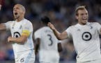Minnesota United's Osvaldo Alonso (left) celebrates with teammate Chase Gasper (right) after Alonso scored a goal against Sporting Kansas City during 
