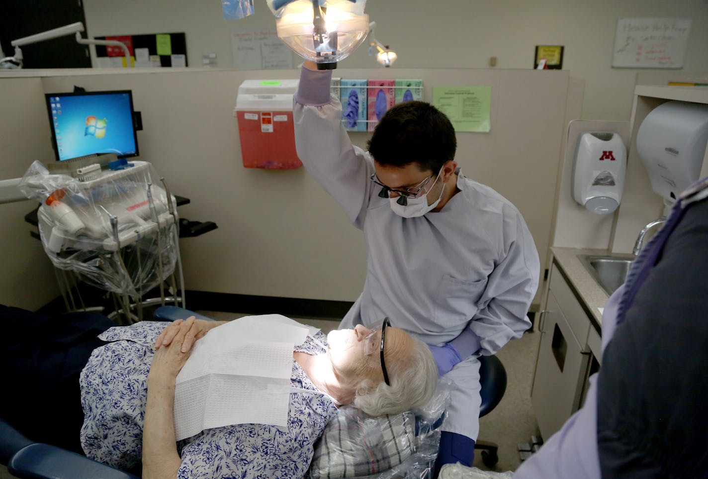 Andrew Bosworth, dental student, prepared to take a look at the teeth of Norma Inemela, New Hope, 87. ] (KYNDELL HARKNESS/STAR TRIBUNE) kyndell.harkness@startribune.com Low-cost options for dental care via U of M Dental School at the Dental School in Minneapolis Min., Tuesday, May 19, 2015.