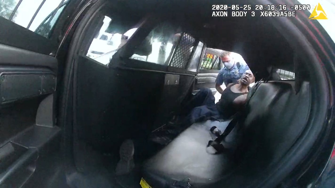 A screenshot from ex-officer Tou Thao's body camera shows ex-officer Thomas Lane attempting to place Floyd in the back of the squad.